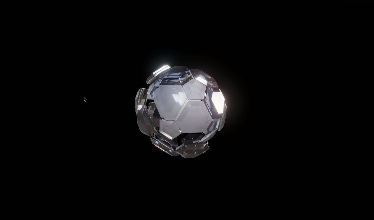 A glossy faceted glass ball on black separating into shards around a core.