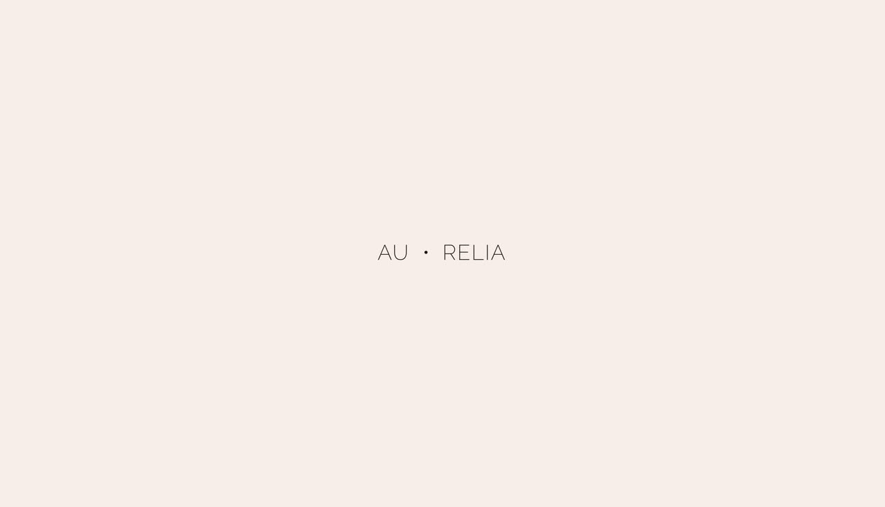 A spaced wordmark on blush pink, a thin line opening into a dark interior photo with a centered tagline.